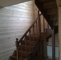 Трёхмаршевая деревянная лестница на второй этаж с поворотом 180° и двумя площадками. Дополнительно лестница оснащена пригласительной ступенью и подступенками. Пораска в один цвет, залакирована. Материал - сосна.